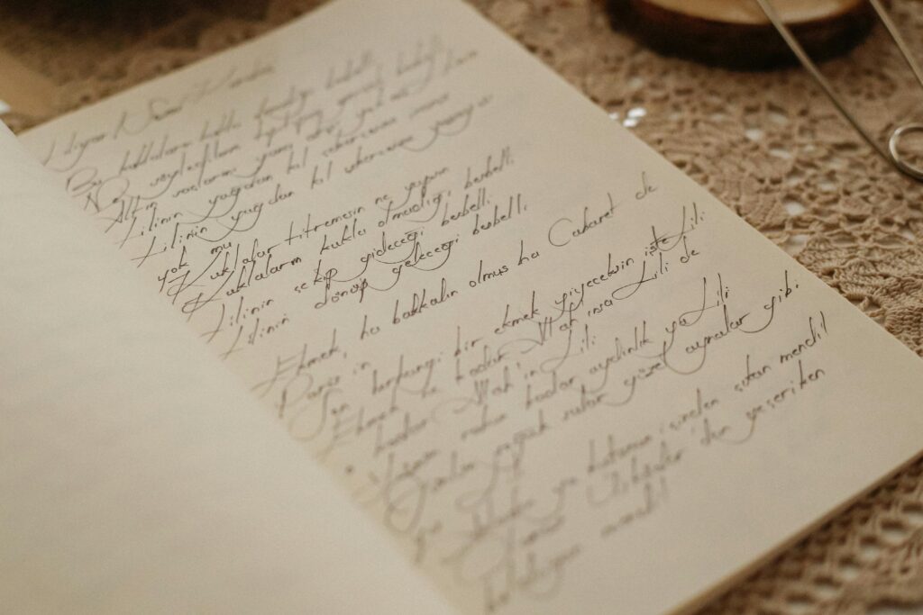 Beautiful close-up of handwritten calligraphy on vintage paper with delicate patterns.